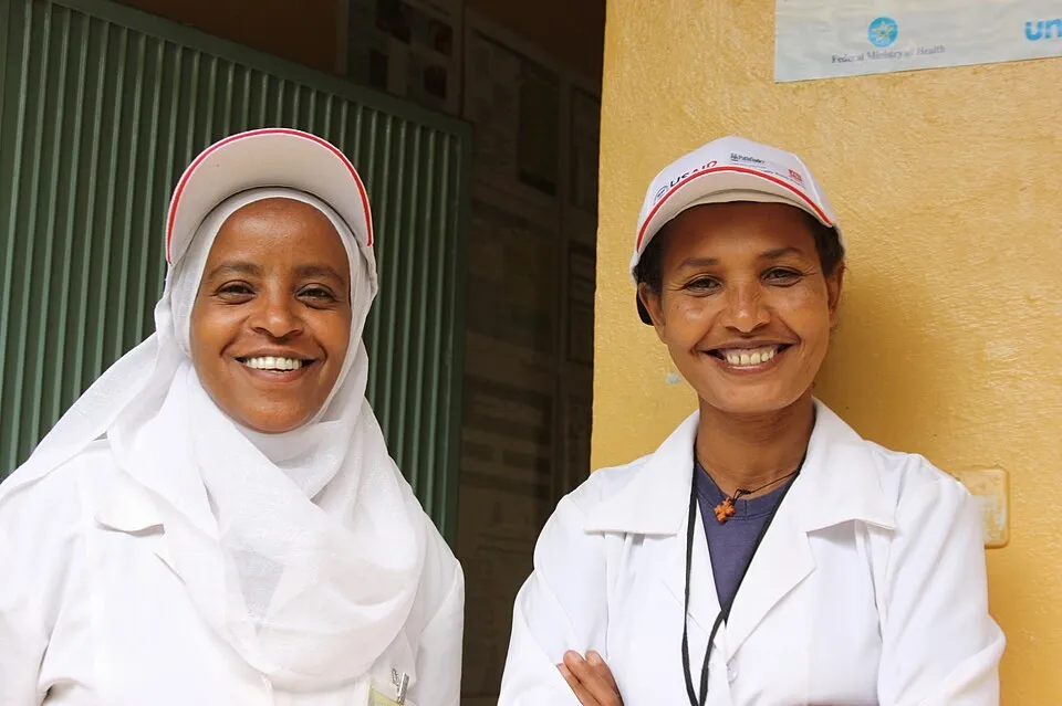 Two smiling community health workers